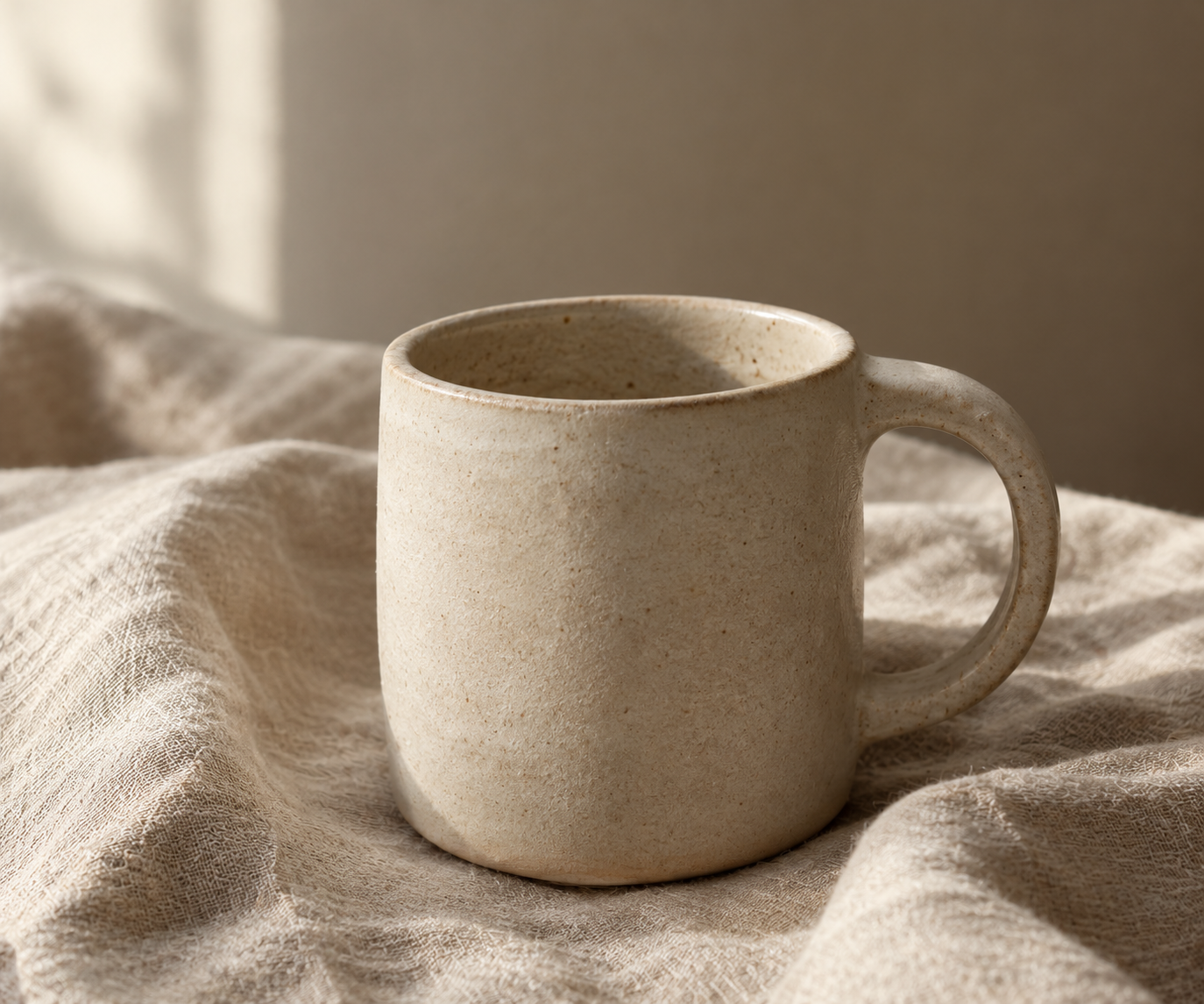 Original photograph of a handmade ceramic mug on natural linen